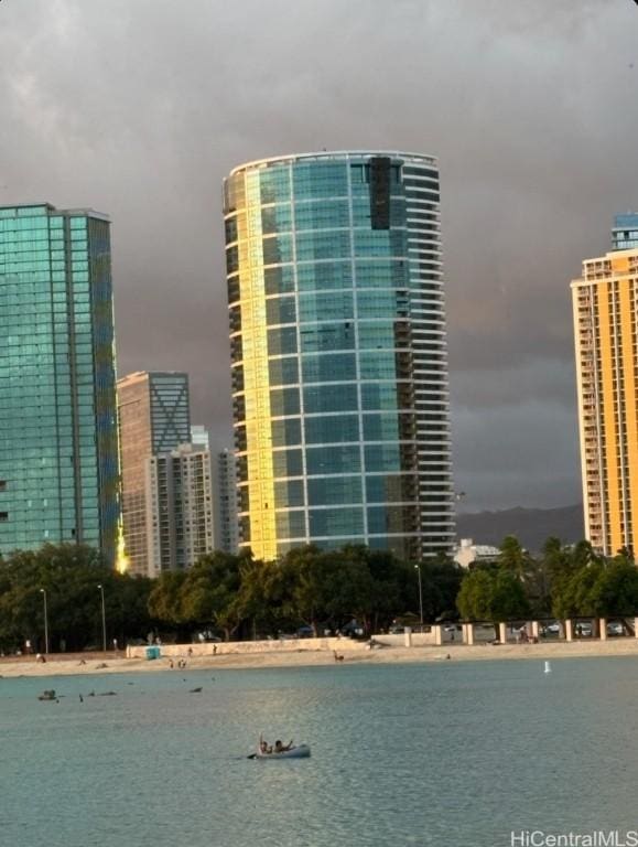 view of building exterior featuring a water view and a view of city