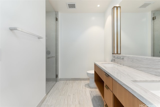 bathroom featuring hardwood / wood-style flooring, vanity, toilet, and a shower with shower door