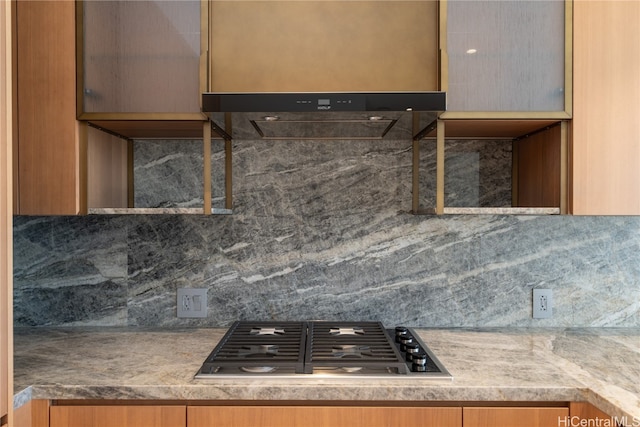 kitchen with decorative backsplash and stainless steel gas stovetop