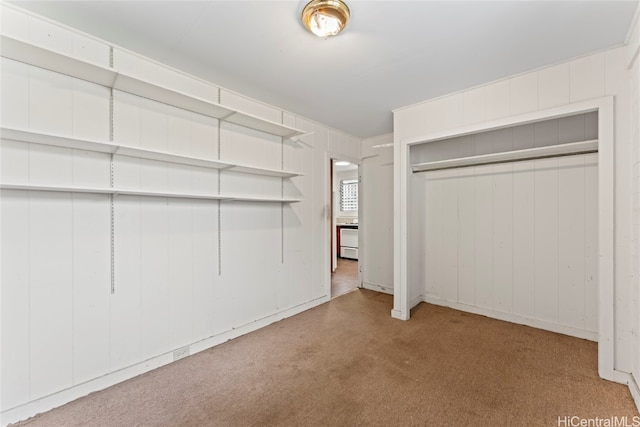 walk in closet featuring light colored carpet