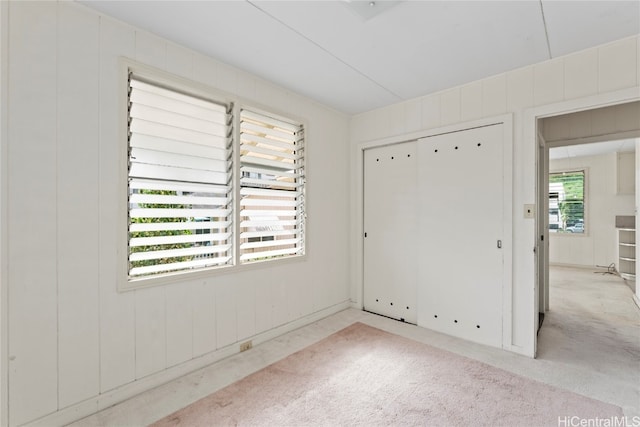 empty room with a healthy amount of sunlight and light colored carpet