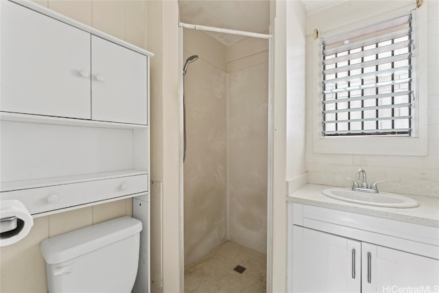 bathroom featuring vanity, toilet, and walk in shower