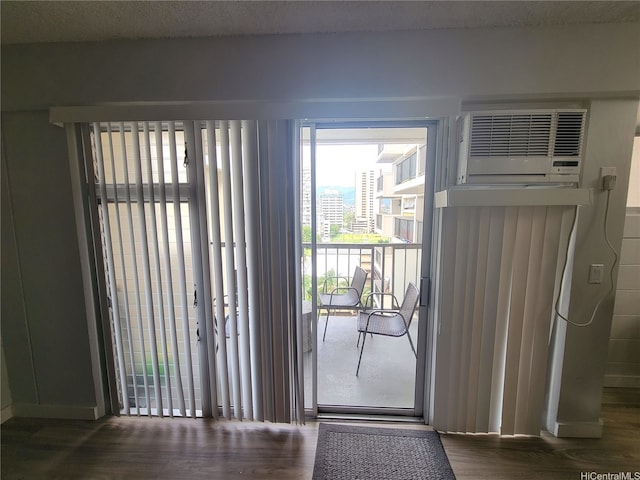 2465 Kuhio Ave Unit 1102, Honolulu, HI 96815 - doorway to outside with wood finished floors and an AC wall unit
