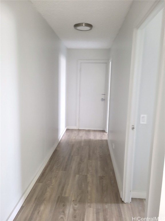 hall with hardwood / wood-style flooring