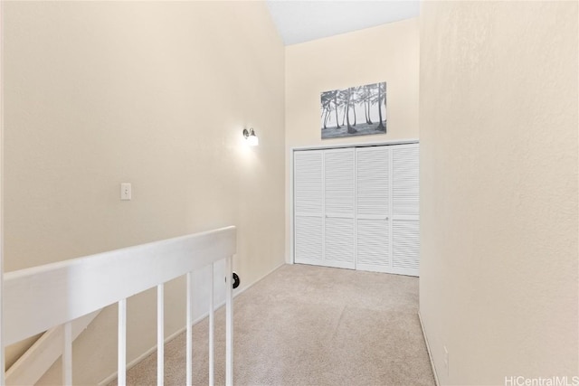 clothes washing area featuring light colored carpet