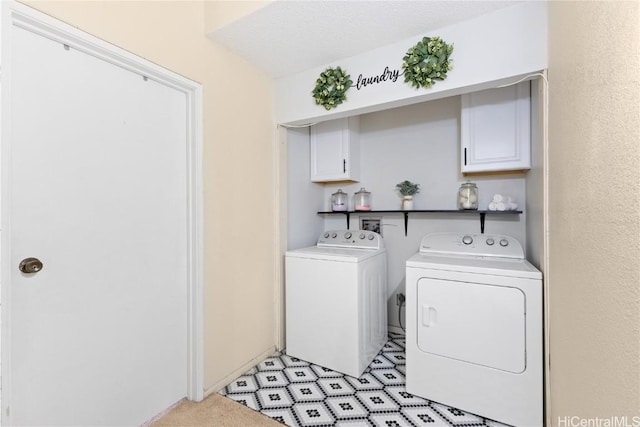 washroom with cabinets, a textured ceiling, and separate washer and dryer