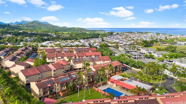 drone / aerial view featuring a water and mountain view