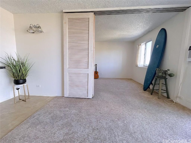 bedroom with a textured ceiling and carpet floors