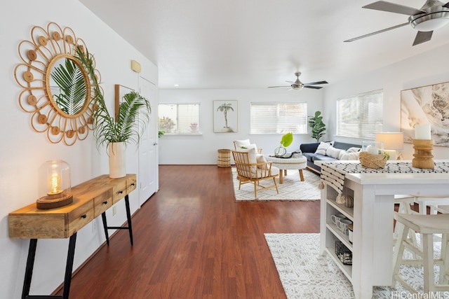 living room with dark hardwood / wood-style floors and ceiling fan