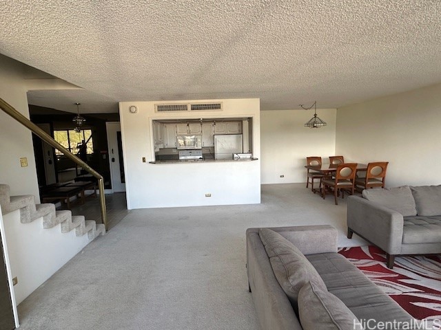 carpeted living room with a textured ceiling