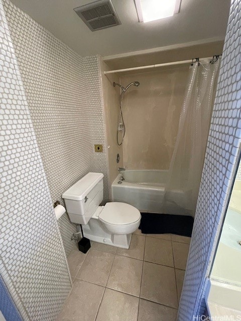 bathroom featuring tile patterned floors, toilet, and shower / bathtub combination with curtain