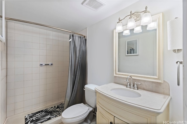 bathroom with curtained shower, vanity, and toilet