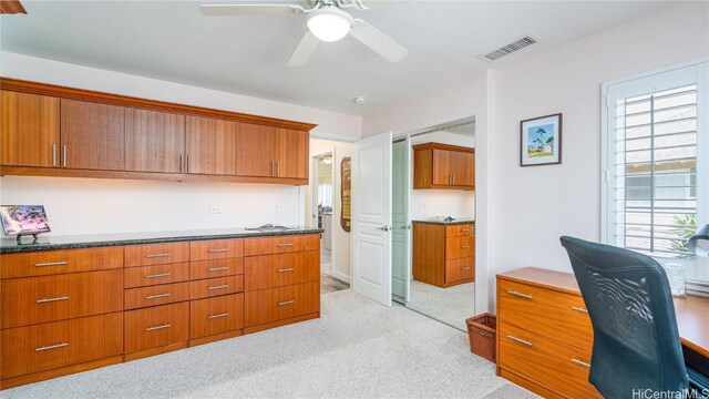 carpeted office with ceiling fan