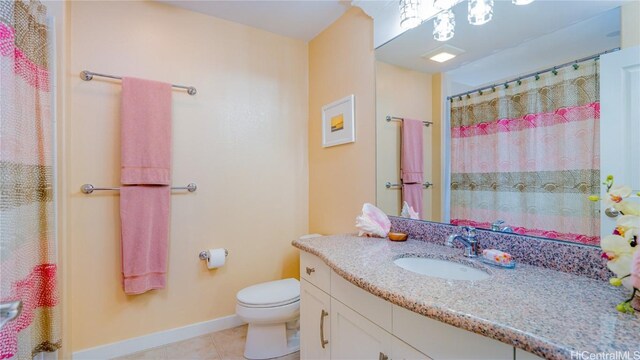 bathroom with tile patterned flooring, vanity, toilet, and curtained shower