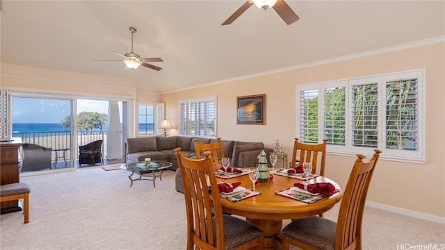 dining area with ceiling fan, a water view, carpet floors, and vaulted ceiling