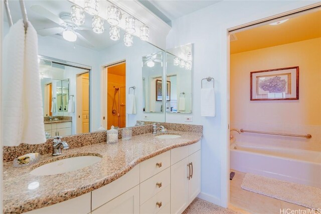 bathroom featuring tile patterned floors, a bathtub, ceiling fan, and vanity