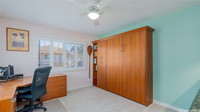 carpeted home office featuring ceiling fan