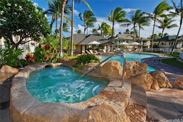 view of swimming pool featuring a hot tub