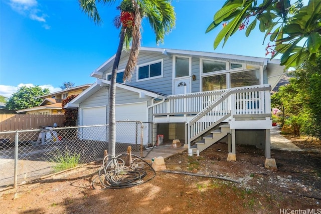 rear view of house featuring a garage