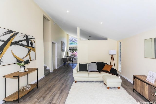 living room with vaulted ceiling and dark wood-type flooring