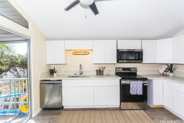 kitchen with white cabinets, dark hardwood / wood-style flooring, stainless steel appliances, and sink