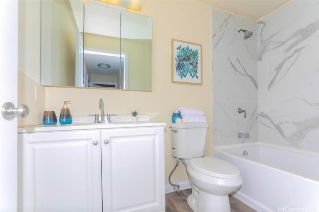 full bathroom with hardwood / wood-style floors, vanity, toilet, and tiled shower / bath