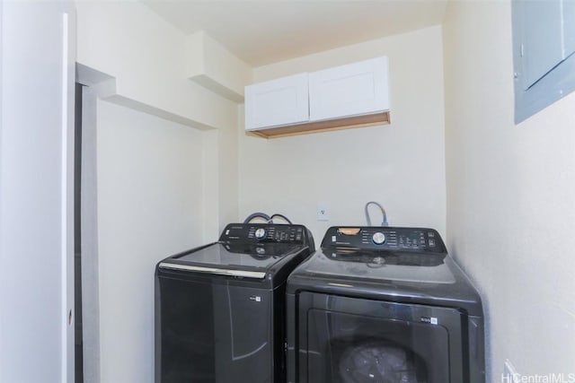 washroom with electric panel and washing machine and clothes dryer