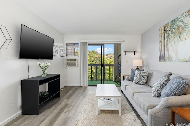 living room featuring cooling unit and light hardwood / wood-style flooring