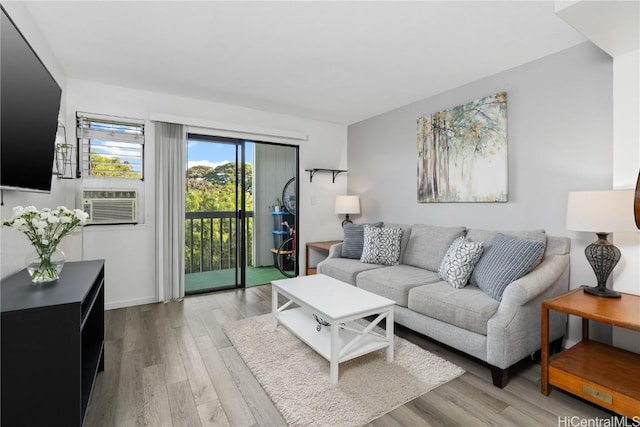 living room with cooling unit and light hardwood / wood-style flooring