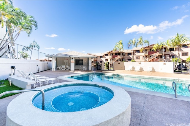 view of pool featuring an in ground hot tub and a patio