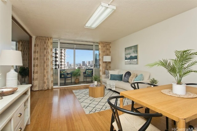 780 Amana St Unit 1506, Honolulu, HI 96814 - living area with floor to ceiling windows, light wood-style flooring, a textured ceiling, and a view of city