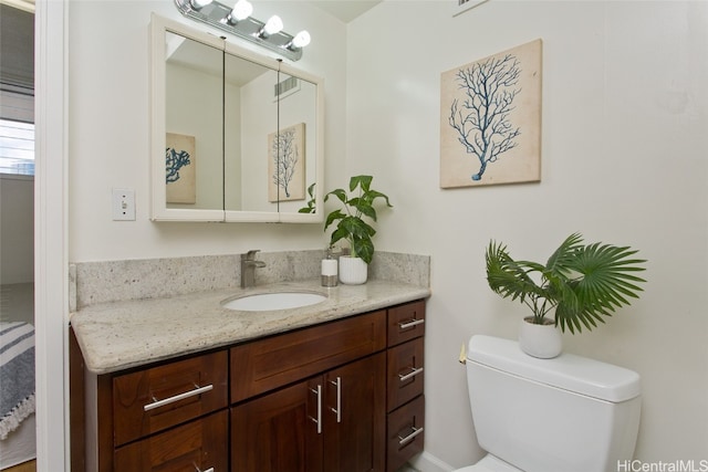 bathroom featuring vanity and toilet