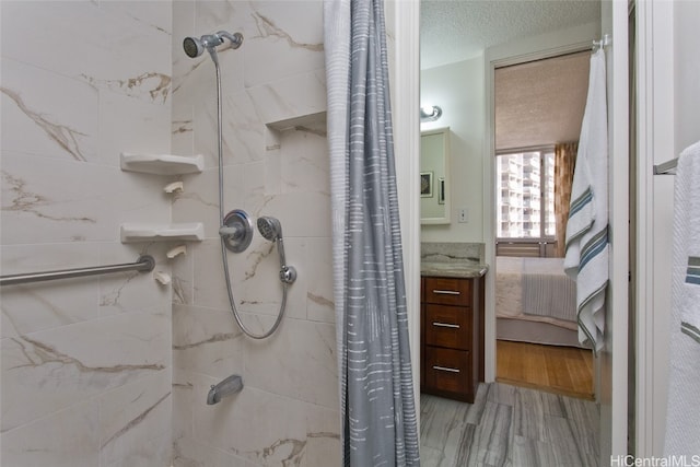 bathroom featuring hardwood / wood-style floors and a textured ceiling