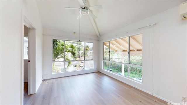 unfurnished sunroom with ceiling fan, lofted ceiling, and a wall unit AC