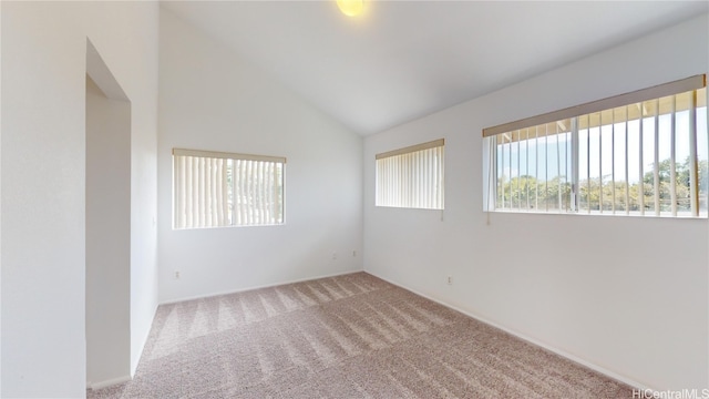 unfurnished room featuring carpet flooring and high vaulted ceiling