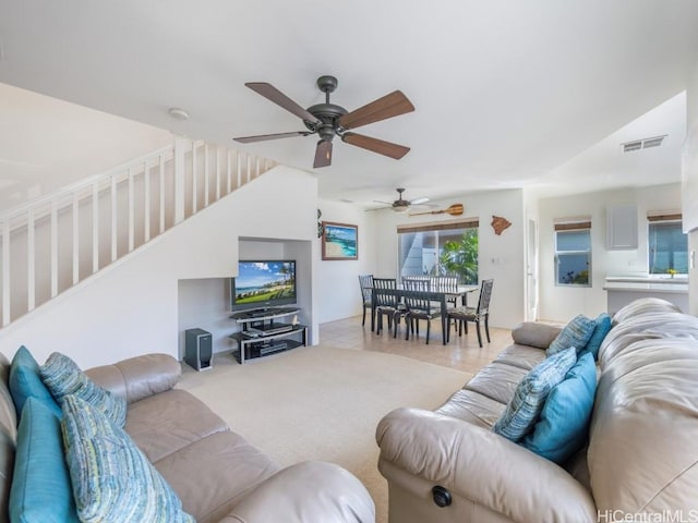 living room featuring ceiling fan and light carpet