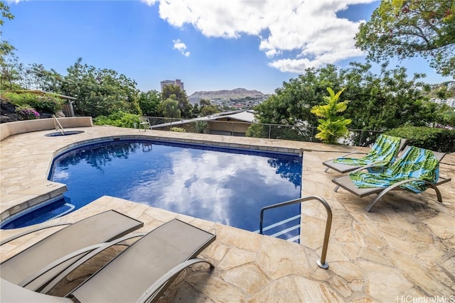 view of swimming pool featuring a mountain view and a patio