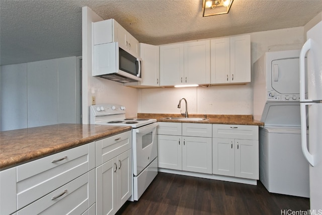 kitchen with white appliances, white cabinets, sink, a textured ceiling, and stacked washer / drying machine