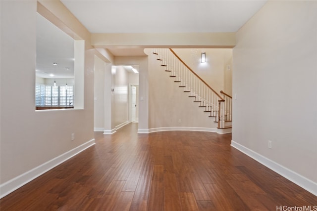 unfurnished living room with dark hardwood / wood-style floors