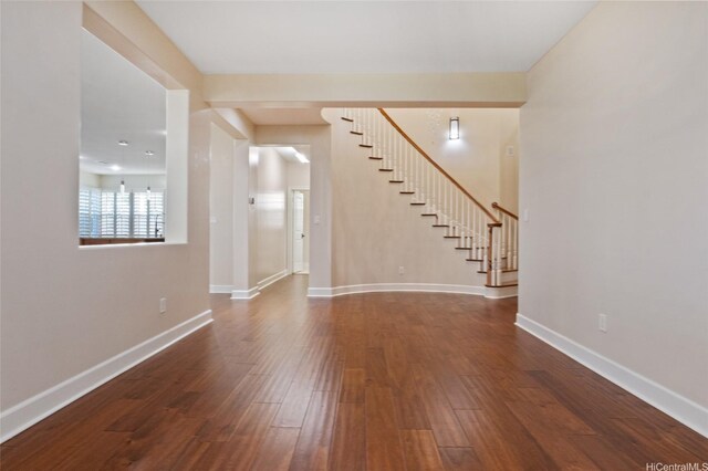 91-1044 Kai Oio St, Ewa Beach, HI 96706 - unfurnished living room with stairs, dark wood-style floors, and baseboards