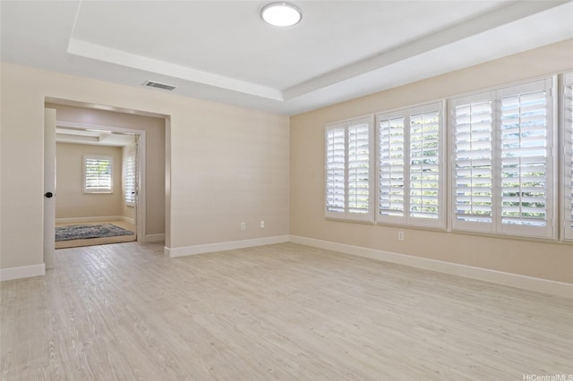 91-1044 Kai Oio St, Ewa Beach, HI 96706 - unfurnished room featuring a tray ceiling, light wood-style flooring, and baseboards