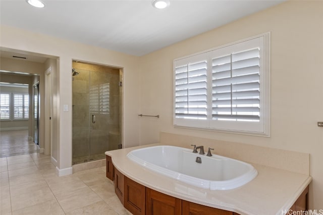 bathroom with tile patterned floors, a wealth of natural light, and shower with separate bathtub