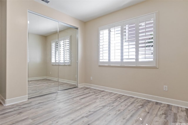 91-1044 Kai Oio St, Ewa Beach, HI 96706 - unfurnished bedroom with a closet, wood finished floors, and baseboards