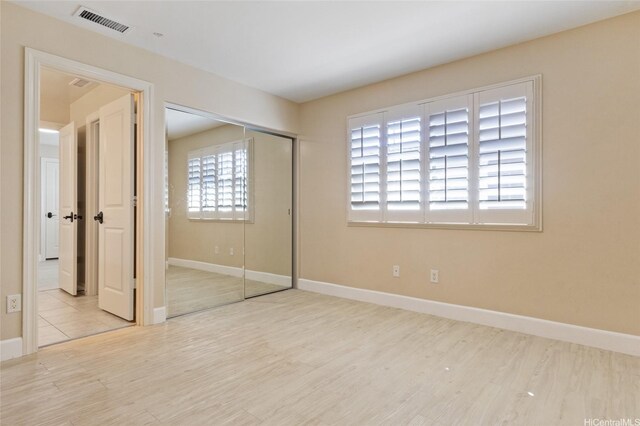 91-1044 Kai Oio St, Ewa Beach, HI 96706 - unfurnished bedroom with wood finished floors, a closet, and baseboards