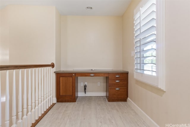 unfurnished office featuring light hardwood / wood-style floors