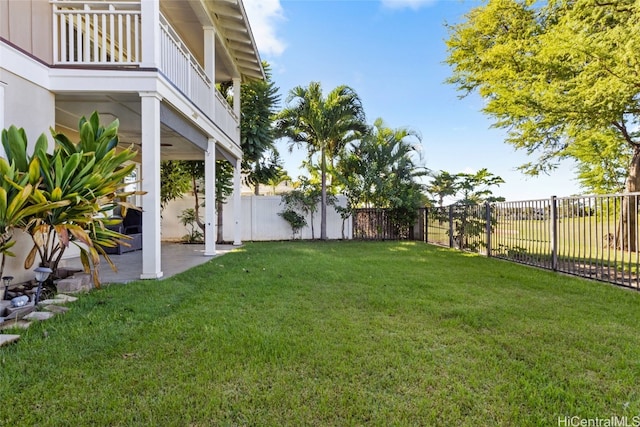 view of yard featuring a balcony and a patio area