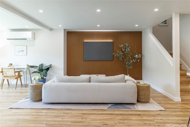 living room featuring hardwood / wood-style floors and a wall mounted AC