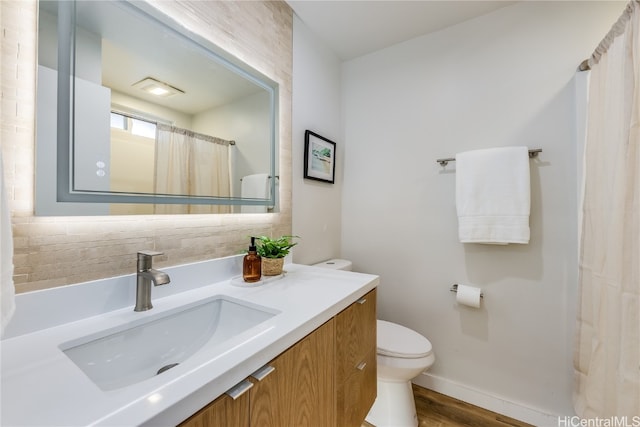 bathroom featuring tasteful backsplash, wood-type flooring, toilet, vanity, and a shower with shower curtain