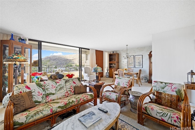 living room with floor to ceiling windows, a mountain view, and a textured ceiling