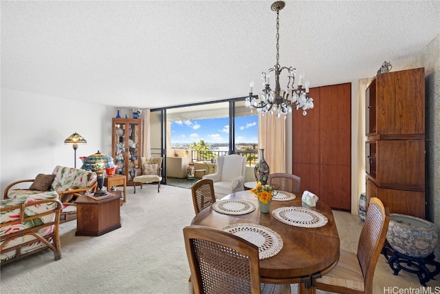 carpeted dining room with floor to ceiling windows, a textured ceiling, and an inviting chandelier